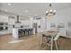 Bright, open kitchen and dining area featuring modern white cabinets, stainless steel appliances, and a rustic dining table at 183 Country Gate Lane Ln, Summerville, SC 29485