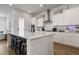 Modern kitchen boasts white cabinets, a large island with seating, and stainless steel appliances at 183 Country Gate Lane Ln, Summerville, SC 29485