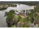 Aerial view of a lake house with private water access, surrounded by mature trees and a sprawling lake at 183 Country Gate Lane Ln, Summerville, SC 29485