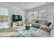Comfortable living room with lots of natural light, a large television, and a sectional sofa at 183 Country Gate Lane Ln, Summerville, SC 29485