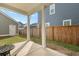 Outdoor patio with sturdy white columns, a concrete floor, and a view of the fenced backyard and neighboring homes at 183 Country Gate Lane Ln, Summerville, SC 29485