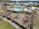 Aerial view of a community playground area with a wood chip play surface, a playground set, mature trees, and walkways at 183 Country Gate Lane Ln, Summerville, SC 29485