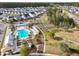 Aerial view of a community pool featuring a uniquely shaped pool, mature trees, and walkways throughout the neighborhood at 183 Country Gate Lane Ln, Summerville, SC 29485