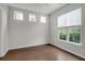 Bright bedroom featuring three large windows, hardwood floors, and neutral walls at 1833 Hubbell Dr, Mount Pleasant, SC 29466