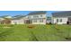 Well-manicured lawn with fire pit and seating area plus screened-in patio at 185 Red Bluff St, Summerville, SC 29483