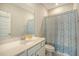 Cozy bathroom with white vanity, mirror and patterned shower curtain at 185 Red Bluff St, Summerville, SC 29483