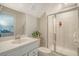 Bright bathroom with a glass shower, white marble floors, and a large vanity mirror at 185 Red Bluff St, Summerville, SC 29483
