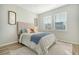 Comfortable bedroom with a tan headboard, decorative pillows, and a white and gray patterned area rug at 185 Red Bluff St, Summerville, SC 29483