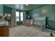 Charming bedroom featuring dark green walls, a crib, and a chair by the window at 185 Red Bluff St, Summerville, SC 29483
