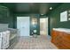 Charming bedroom featuring dark green walls, a crib, and a dresser at 185 Red Bluff St, Summerville, SC 29483