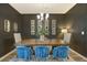 Chic dining area featuring a rustic wood table, stylish blue chairs, and modern decor at 185 Red Bluff St, Summerville, SC 29483
