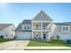 Charming two-story home with grey siding, upper and lower porches, and well-kept lawn at 185 Red Bluff St, Summerville, SC 29483