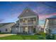 Charming two-story home featuring a welcoming front porch and manicured lawn at 185 Red Bluff St, Summerville, SC 29483