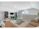 Large game room with a wall mounted TV, sofa, games, and lots of natural light at 185 Red Bluff St, Summerville, SC 29483