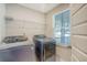 Well-lit laundry room features modern washer and dryer units, and a window at 185 Red Bluff St, Summerville, SC 29483