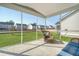 Covered porch with wicker seating, screened windows with view of backyard at 185 Red Bluff St, Summerville, SC 29483