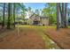 Spacious backyard surrounded by mature trees, featuring a screened porch and manicured pine straw at 1883 Hall Point Rd, Mount Pleasant, SC 29466