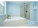 Well-lit bathroom with a garden tub and glass enclosed shower offering relaxation and convenience at 1883 Hall Point Rd, Mount Pleasant, SC 29466