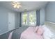 Bright bedroom with two windows and soft pink bedding creating a relaxing and welcoming space at 1883 Hall Point Rd, Mount Pleasant, SC 29466