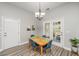 Cozy dining area featuring a wood table, four blue chairs, and a modern chandelier at 1883 Hall Point Rd, Mount Pleasant, SC 29466