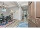 Stylish dining room with modern chandelier, beautiful wood floors, and a glimpse of other rooms at 1883 Hall Point Rd, Mount Pleasant, SC 29466