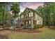 Charming two-story home with a welcoming front porch, American flag, palm tree, and a well-manicured lawn at 1883 Hall Point Rd, Mount Pleasant, SC 29466