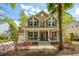 Inviting home featuring a charming front porch, manicured landscaping, and an attached two car garage at 1883 Hall Point Rd, Mount Pleasant, SC 29466