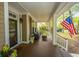 Inviting covered front porch with comfortable seating, and a peek through the front door at 1883 Hall Point Rd, Mount Pleasant, SC 29466