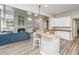 Modern kitchen with a breakfast bar overlooking the living area and a cozy fireplace at 1883 Hall Point Rd, Mount Pleasant, SC 29466