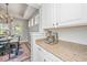 Bright kitchen featuring granite countertops, white cabinets, and stainless steel appliances at 1883 Hall Point Rd, Mount Pleasant, SC 29466