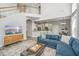 Open-concept living room with a blue sofa, view of kitchen, and a second-floor balcony at 1883 Hall Point Rd, Mount Pleasant, SC 29466
