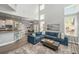 Spacious living room with a blue sofa, open to the kitchen and dining area, and plenty of natural light at 1883 Hall Point Rd, Mount Pleasant, SC 29466