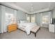 Bright main bedroom with tray ceilings, multiple windows, and neutral decor at 1883 Hall Point Rd, Mount Pleasant, SC 29466