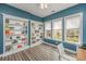 Stylish home office with custom built-in bookshelves, bathed in natural light from large windows at 1883 Hall Point Rd, Mount Pleasant, SC 29466