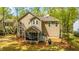 Rear exterior view of home with screened porch and well-maintained lawn, showcasing its outdoor living space at 1883 Hall Point Rd, Mount Pleasant, SC 29466