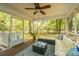 Inviting screened porch with outdoor seating, ceiling fan, and views of the lush backyard at 1883 Hall Point Rd, Mount Pleasant, SC 29466