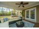 Cozy screened porch with plush seating, ceiling fan, and access to the backyard and home at 1883 Hall Point Rd, Mount Pleasant, SC 29466