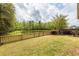 Expansive backyard featuring a scenic pond view and secure wood fencing, perfect for outdoor enjoyment at 201 Island Green Rd, Goose Creek, SC 29445