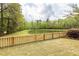 Picturesque backyard featuring a tranquil pond view and wood fencing, ideal for outdoor relaxation at 201 Island Green Rd, Goose Creek, SC 29445