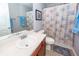 Bright bathroom featuring vanity and shower with a seashell curtain at 201 Island Green Rd, Goose Creek, SC 29445