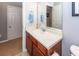 Well-lit bathroom featuring a cherry vanity, large mirror, and neutral walls at 201 Island Green Rd, Goose Creek, SC 29445