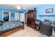 Bright blue bedroom features a ceiling fan, wooden furniture, and a comfortable workspace at 201 Island Green Rd, Goose Creek, SC 29445