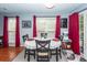 Dining room features a round table with seating for four, lots of light, and red curtains at 201 Island Green Rd, Goose Creek, SC 29445