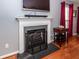 Classic fireplace with a white mantel, hearth, and screen, perfect for cozy evenings in the living room at 201 Island Green Rd, Goose Creek, SC 29445