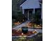 Inviting front yard with landscaped walkway and garden lighting, enhancing curb appeal and nighttime ambiance at 201 Island Green Rd, Goose Creek, SC 29445