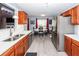 Open-concept kitchen boasts stainless steel appliances and wood cabinets; dining room is visible at 201 Island Green Rd, Goose Creek, SC 29445