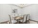 Elegant dining room with neutral wallpaper, a modern chandelier, and seating for six at 203 Belfort Pl, Summerville, SC 29486