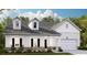 Charming two-story home with stone accents, white siding, and a welcoming front porch at 203 Belfort Pl, Summerville, SC 29486