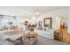 Bright, open-concept living area with a large sofa, island seating, and wood flooring at 203 Belfort Pl, Summerville, SC 29486