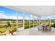 Relaxing screened porch with comfortable seating and a view of the beautiful natural landscape at 203 Belfort Pl, Summerville, SC 29486